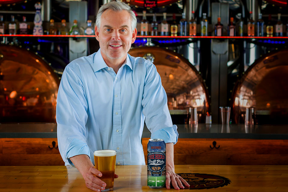 Colin Cowherd with a can of The Herd Hazy IPA